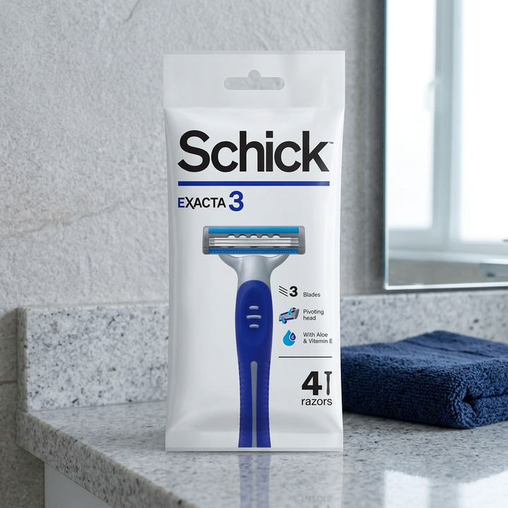 Schick Exacta3 four-razor pack on a bathroom counter beside a navy towel