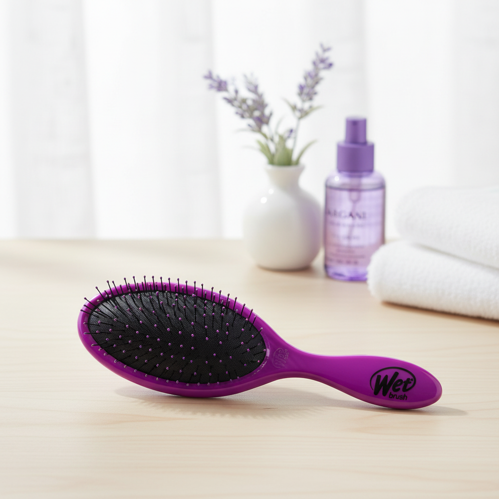 Purple compact oval hair brush in an elegant indoor setting