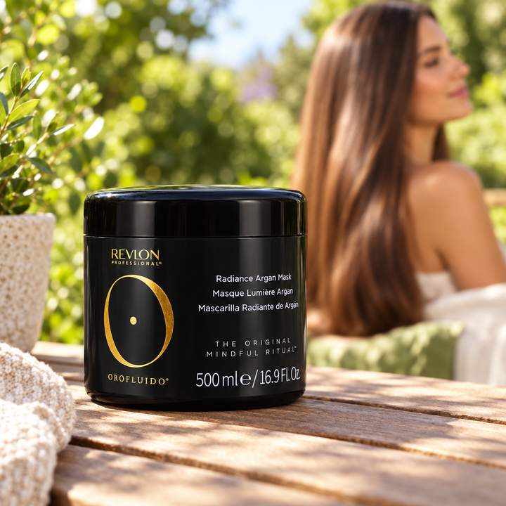 Revlon Orofluido Radiance Argan Mask jar in a sunny garden setting