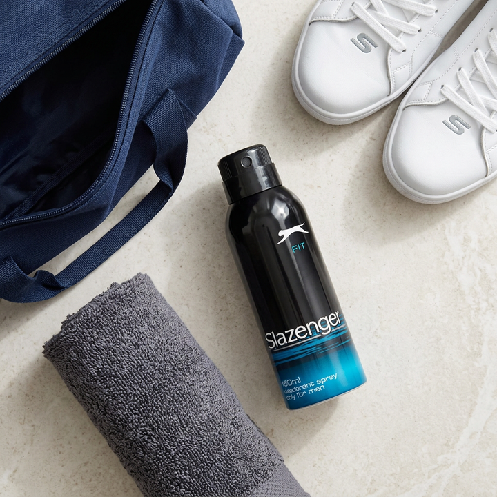 Overhead flatlay of Slazenger Blue deodorant with gym bag towel and trainers