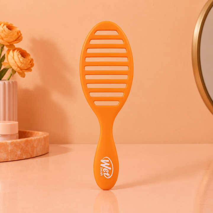 Orange Speed Dry brush indoors on peach background, back view