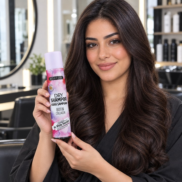 Model holding Morfose Biotin Collagen Dry Shampoo in salon