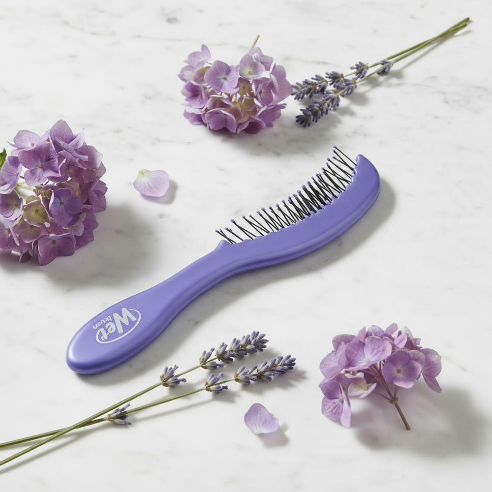 WetBrush purple detangling comb on marble with flowers