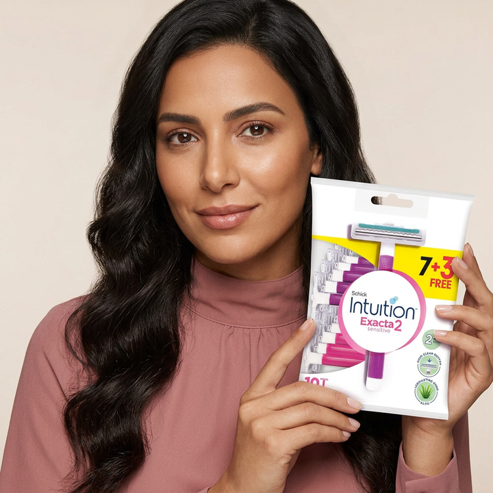 Close-up model holding Schick Intuition Exacta2 Sensitive pack
