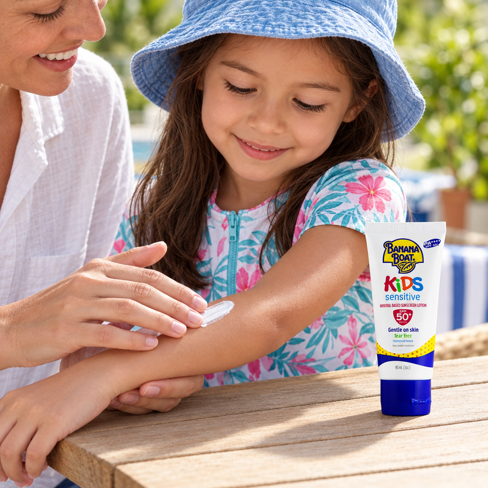 Parent applying Banana Boat Kids Sensitive sunscreen to child's arm
