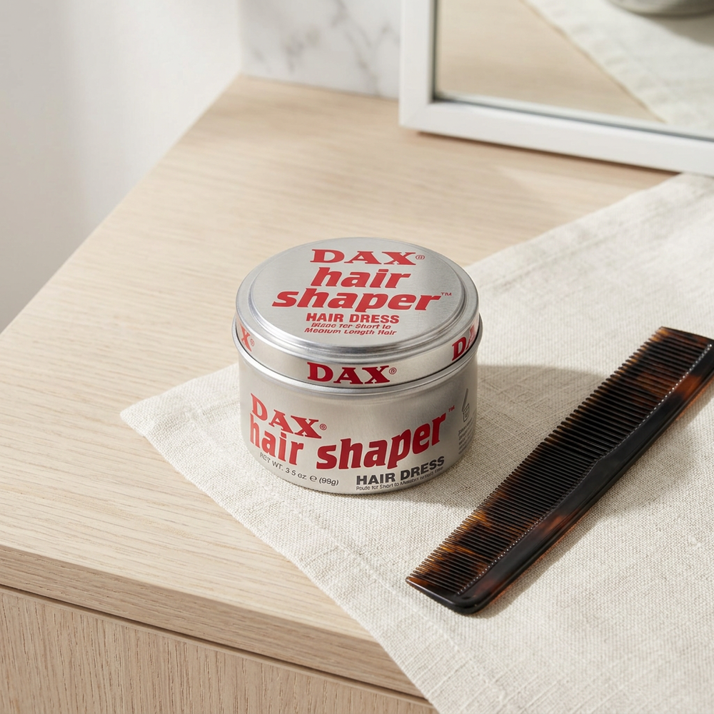 DAX Hair Shaper 99g silver tin beside styling comb